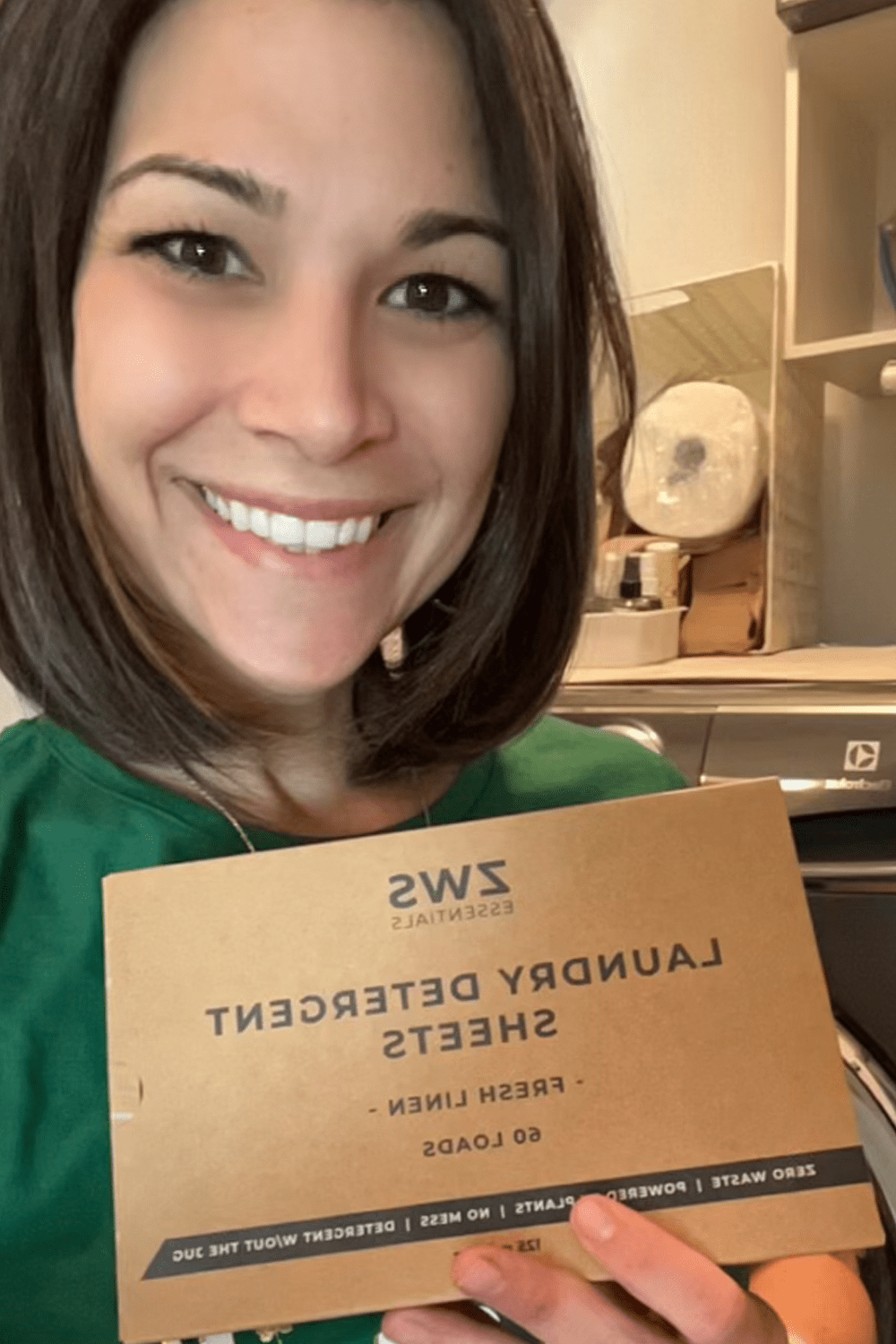 customer holding up laundry detergent sheets