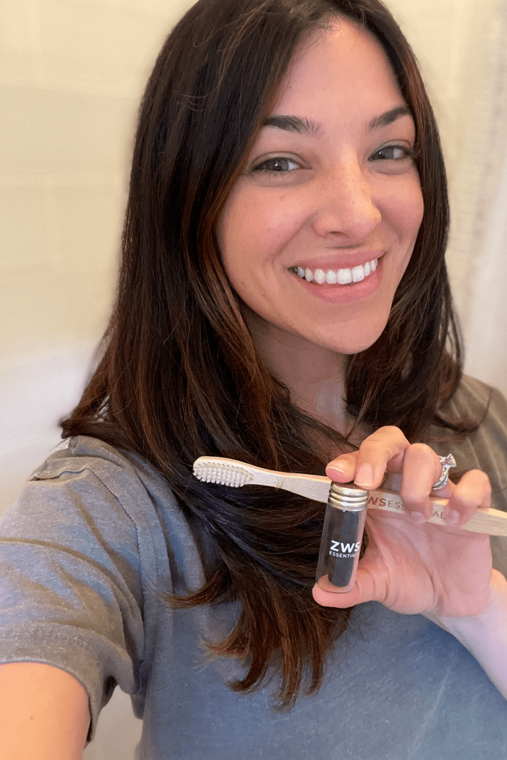 dana holding bamboo toothbrush and floss