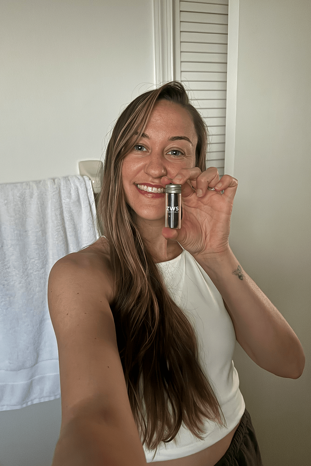 model holding bamboo charcoal floss in bathroom