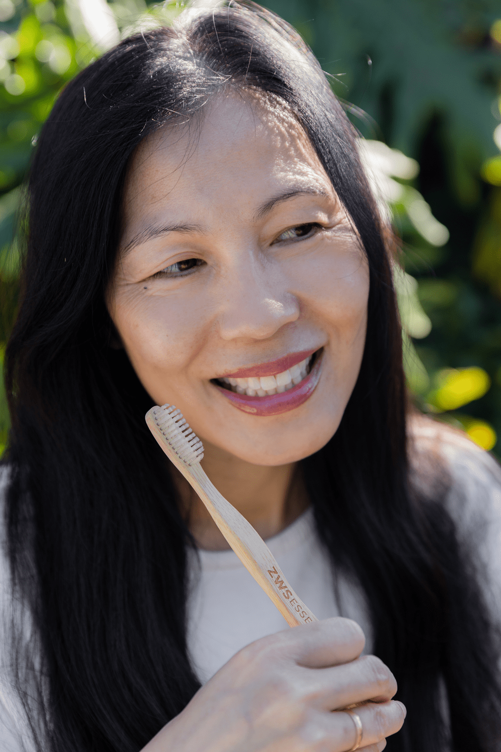 older women holding bamboo toothbrush older women holding bamboo toothbrush