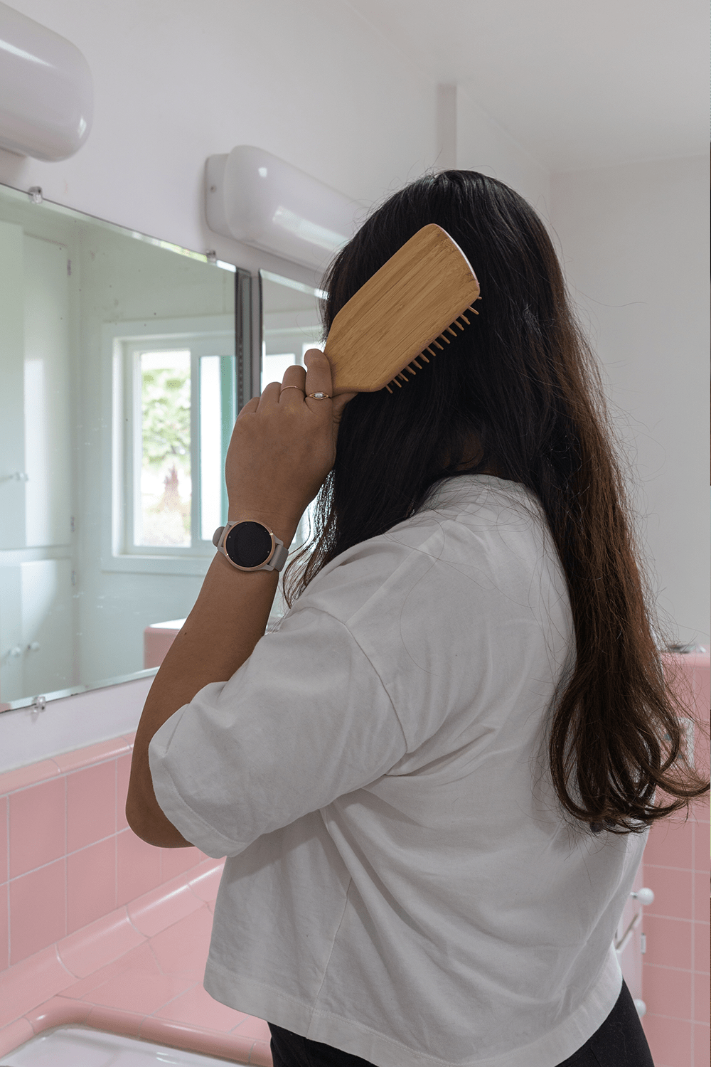women brushing hair with bamboo hairbrush