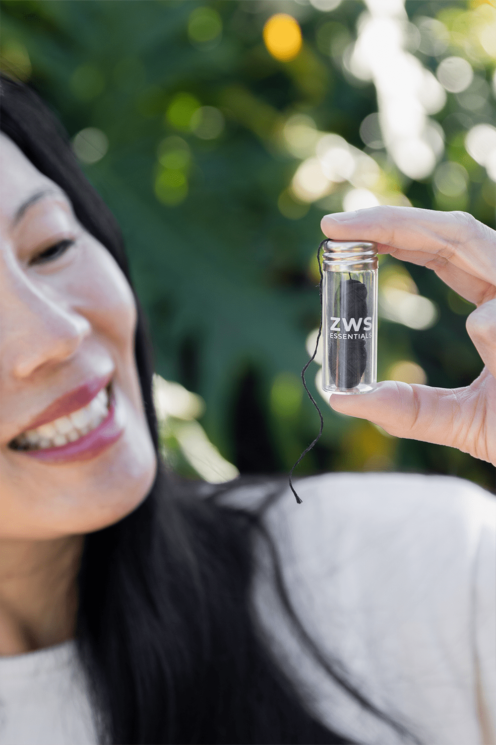 women smiling holding bamboo floss